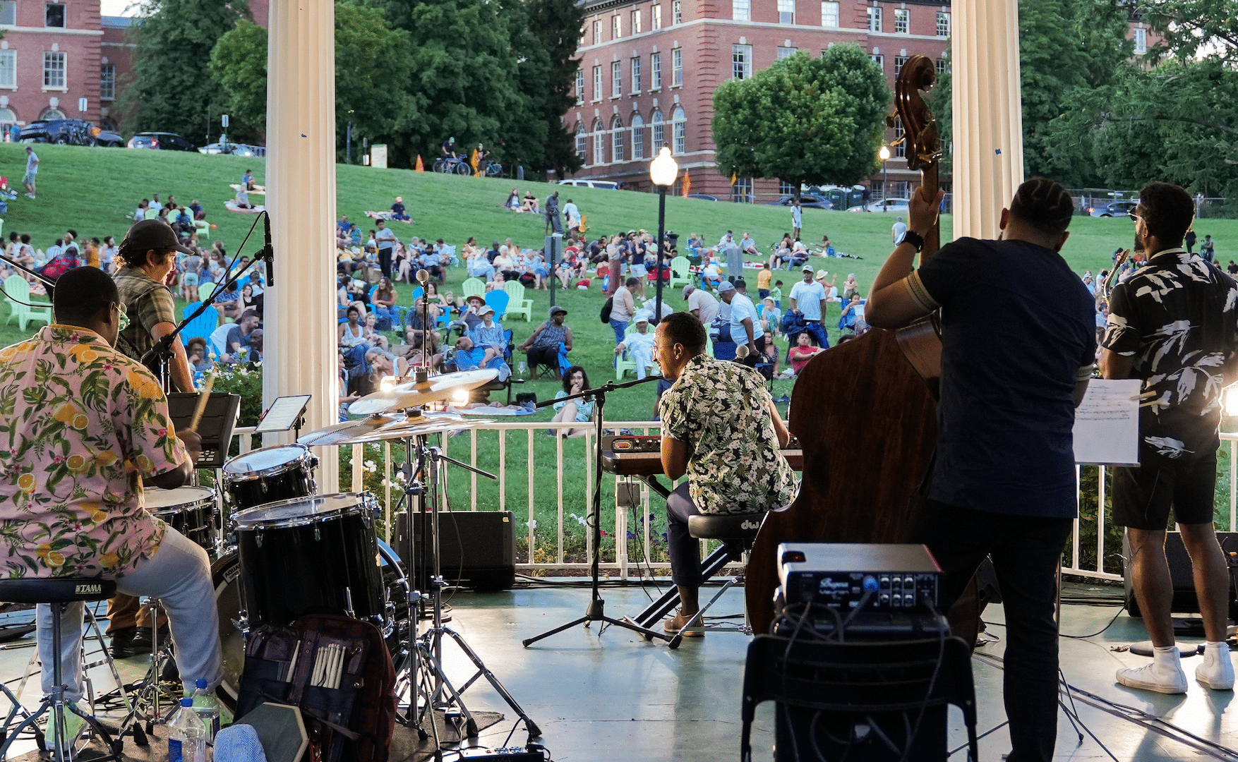 A band plays music outside for a crowd.
