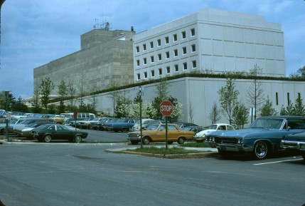 Exterior of a building with a parking lot in front.