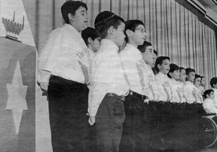 A black and white photo of a row of small boys.